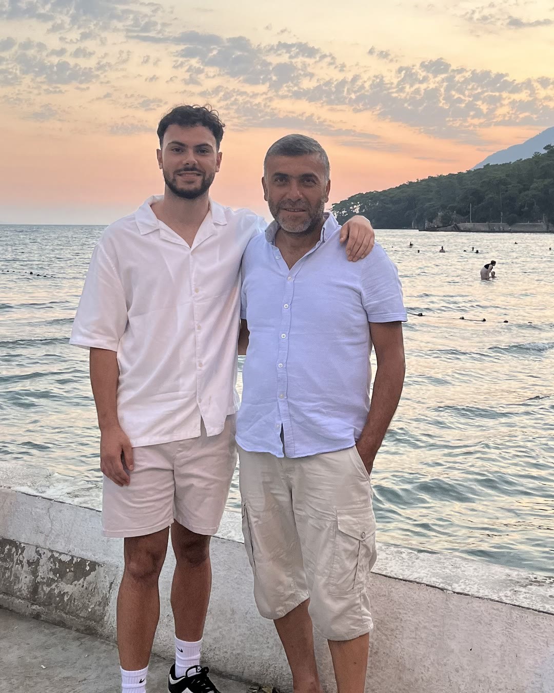 Enes and his dad at the sea at sunset