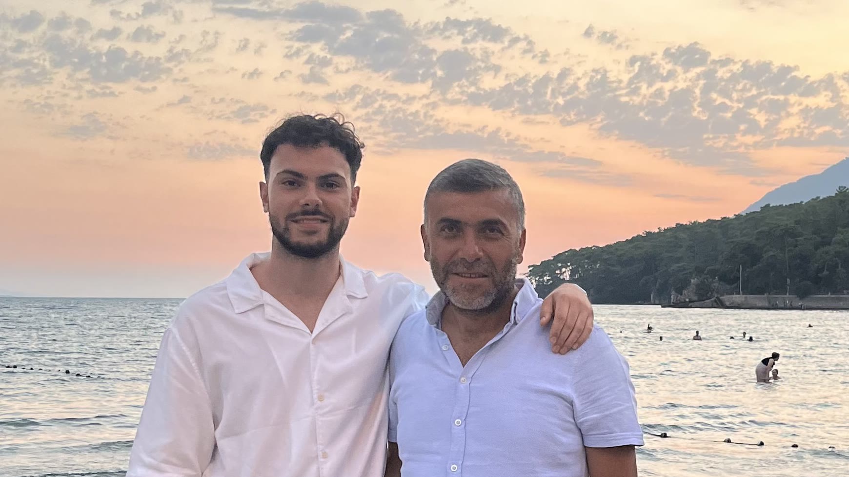 Enes and his dad at the sea at sunset